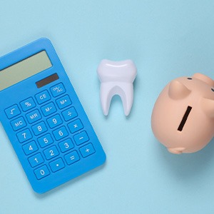 Calculator, piggy bank, and tooth