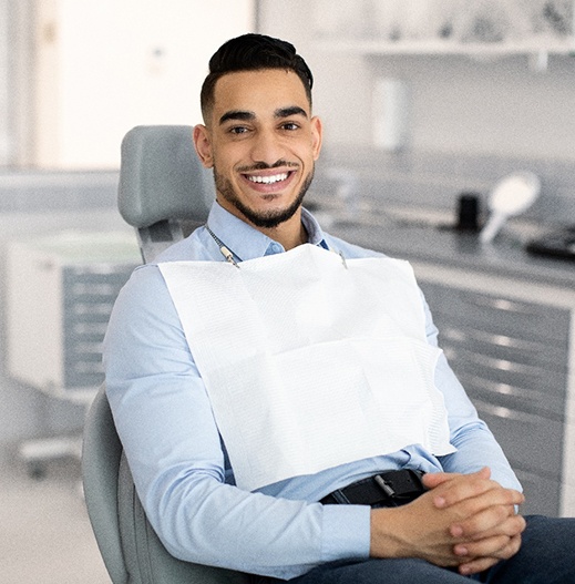 Patient smiling while sitting in treatment chair
